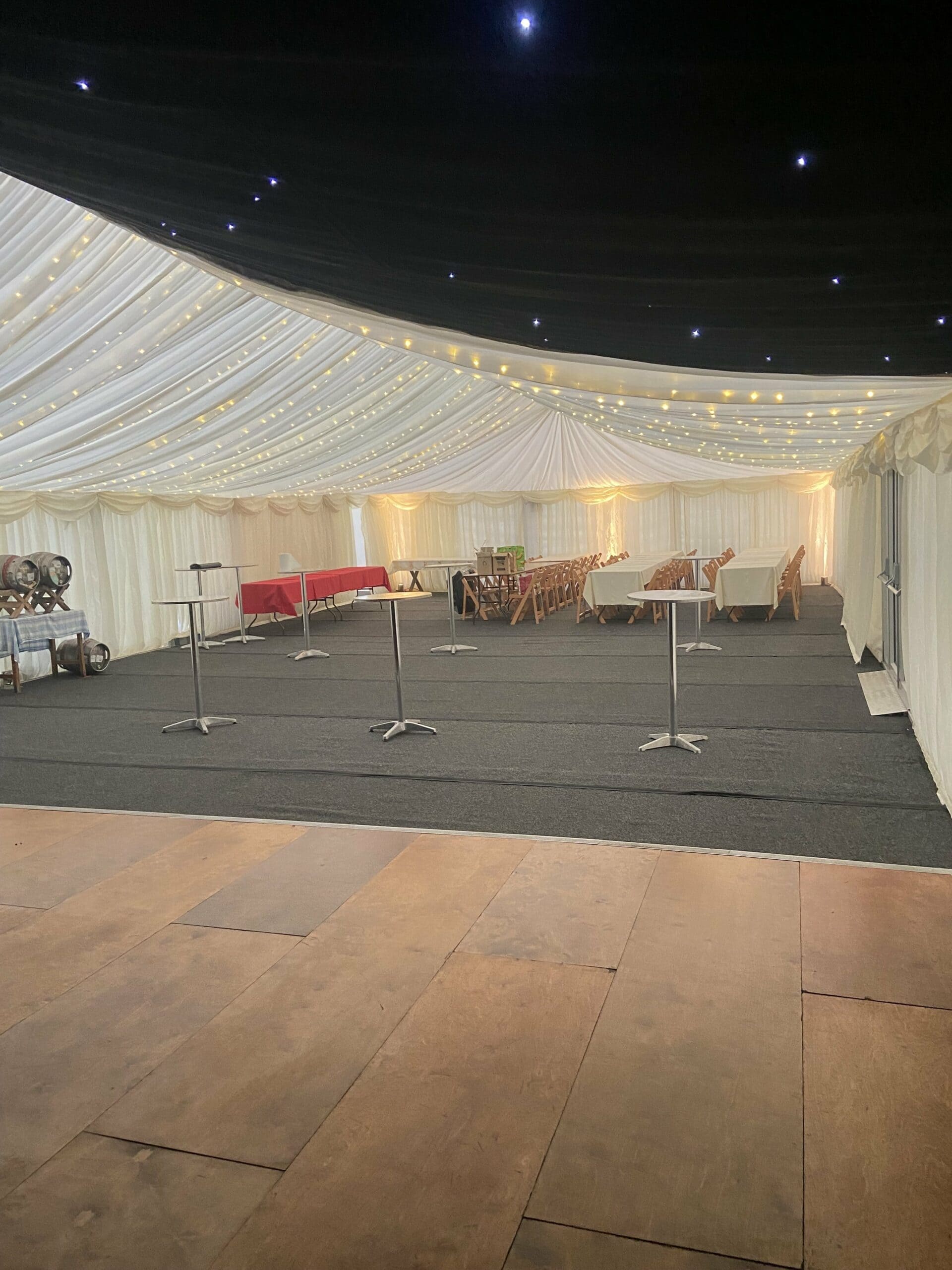Elegant wedding marquee layout showcasing styled seating, lighting, and decor provided through marquee furniture hire services.
