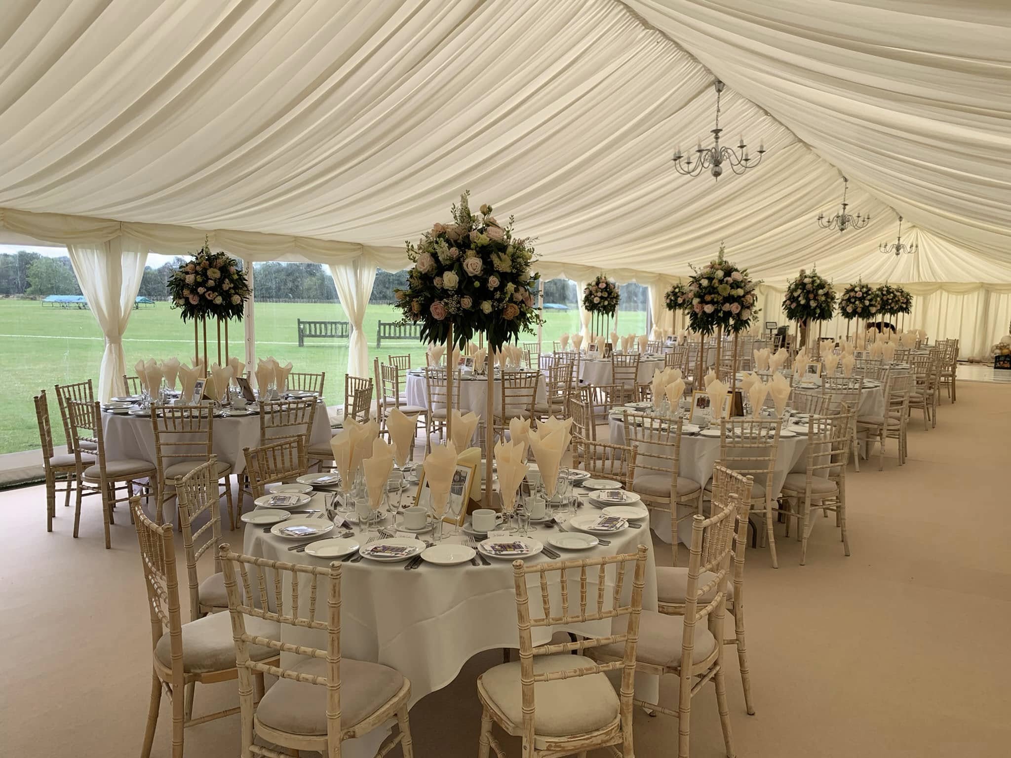 Marquee wedding reception with elegant wedding chair to hire setup.